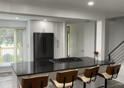 Kitchen Island with chairs showing custom cabinetry